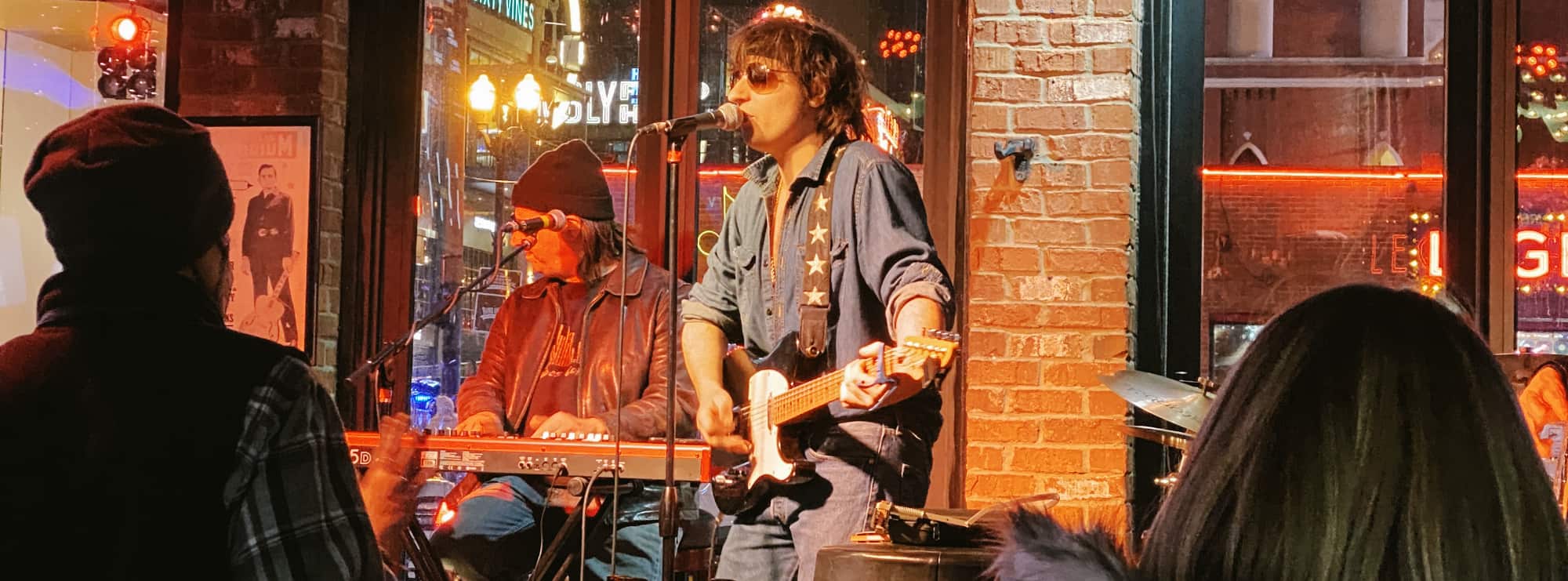 bar singer on guitar in College Station