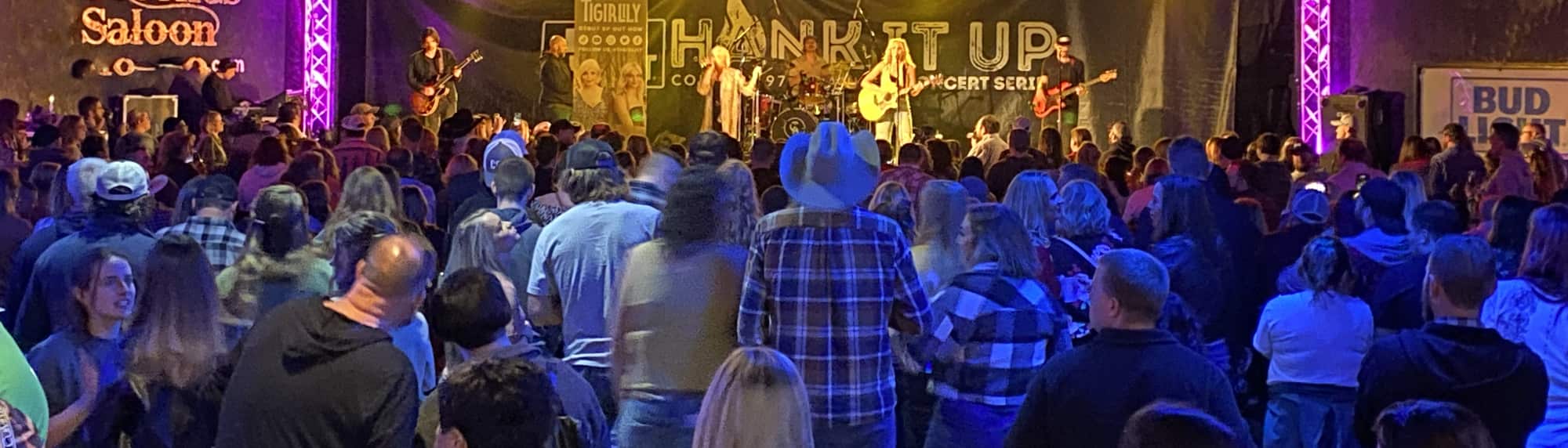 country concert with fans wearing cowboy hats College Station